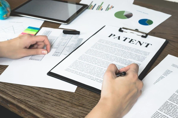 zapisane kartki papieru z wyróżniającym się napisem patent